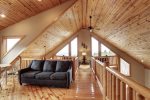 Eagle Trail Lodge loft sitting area with wood ceilings.  